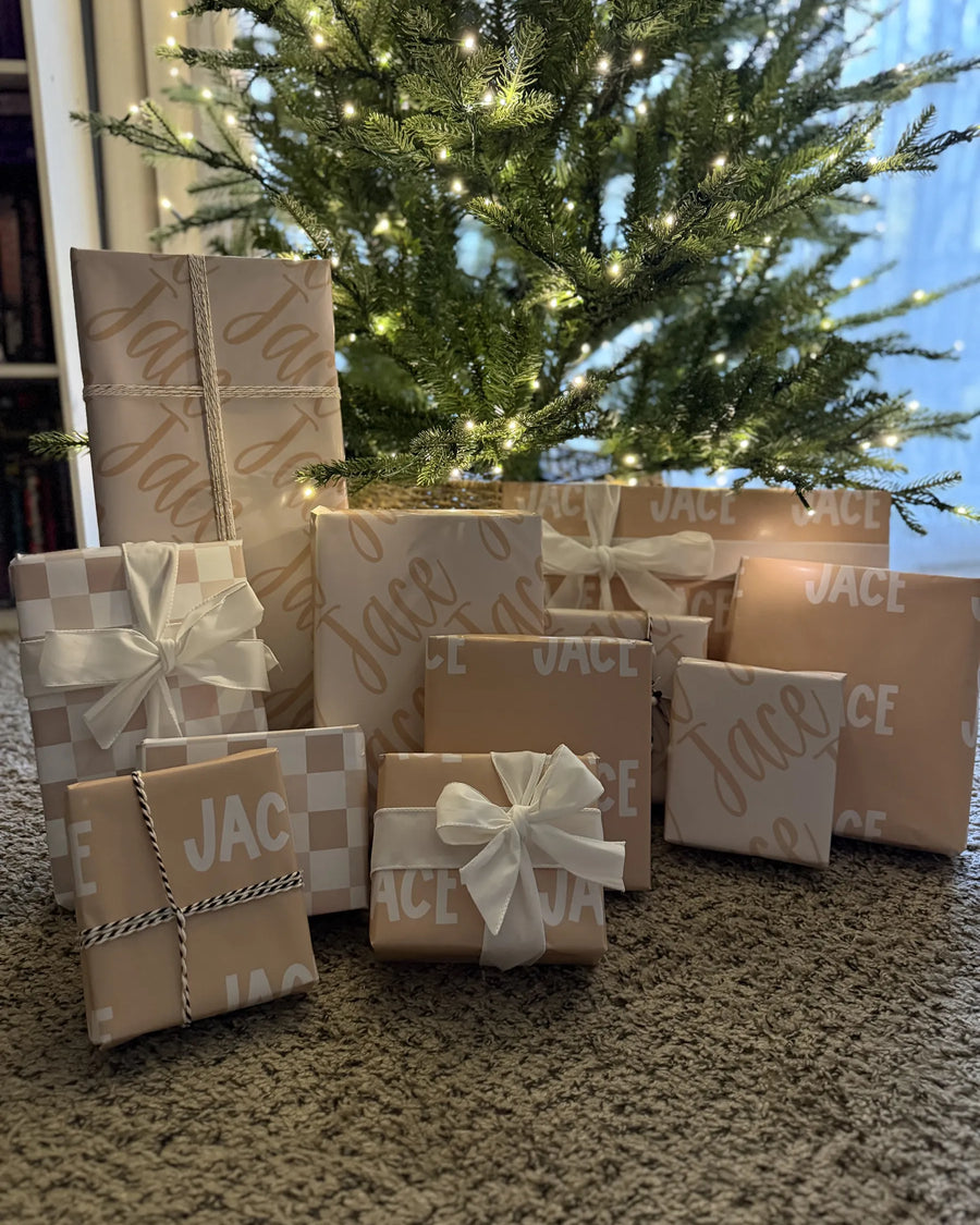 A pile of wrapped gifts under a tree