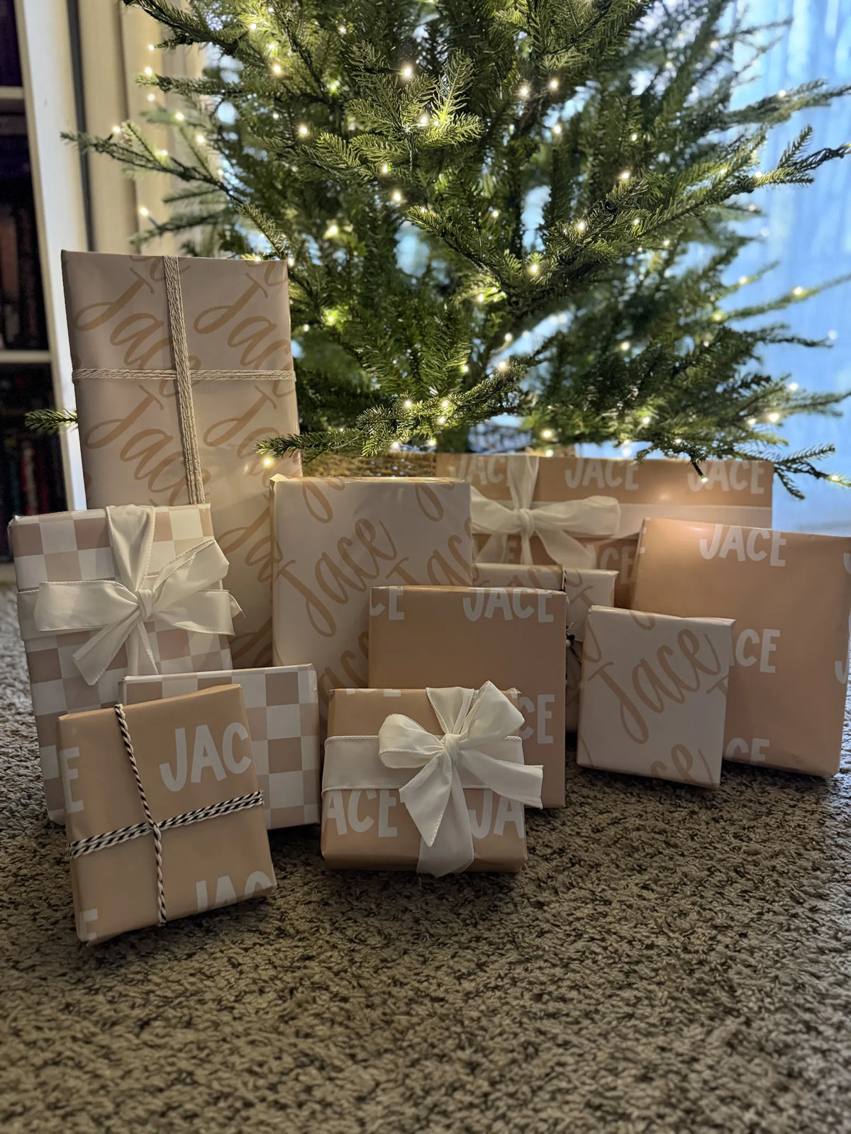 Gifts in personalized Paperbloom paper under a Christmas tree