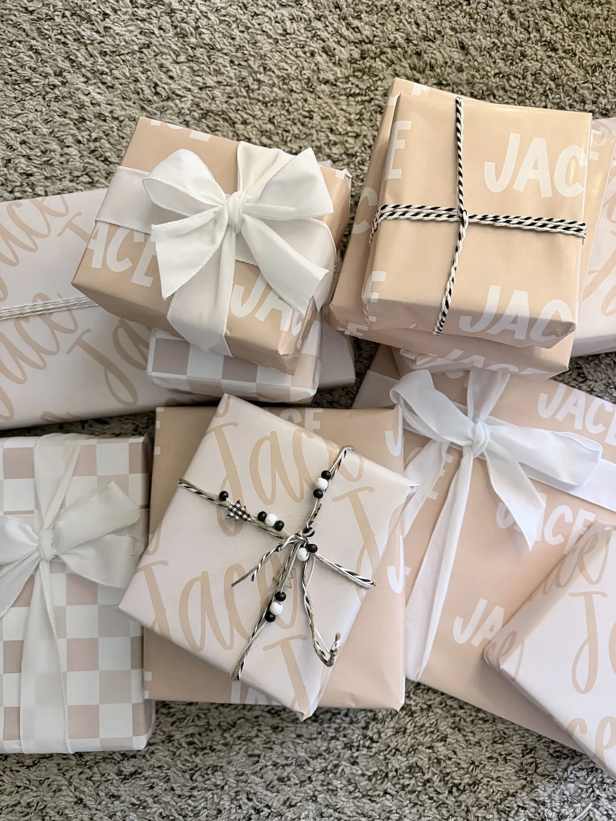 A pile of gifts wrapped in cream Paperbloom name paper