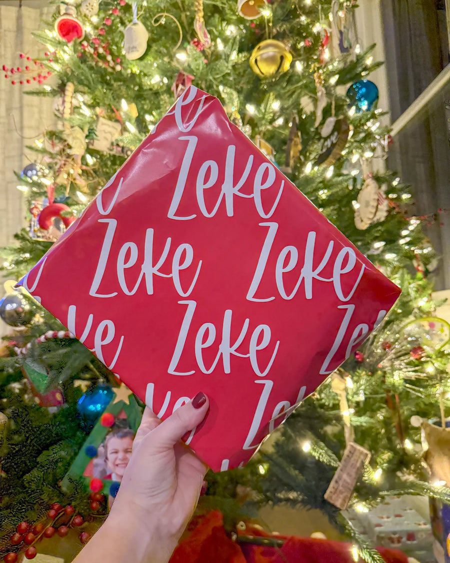 Red wrapping paper printed with the name Zeke
