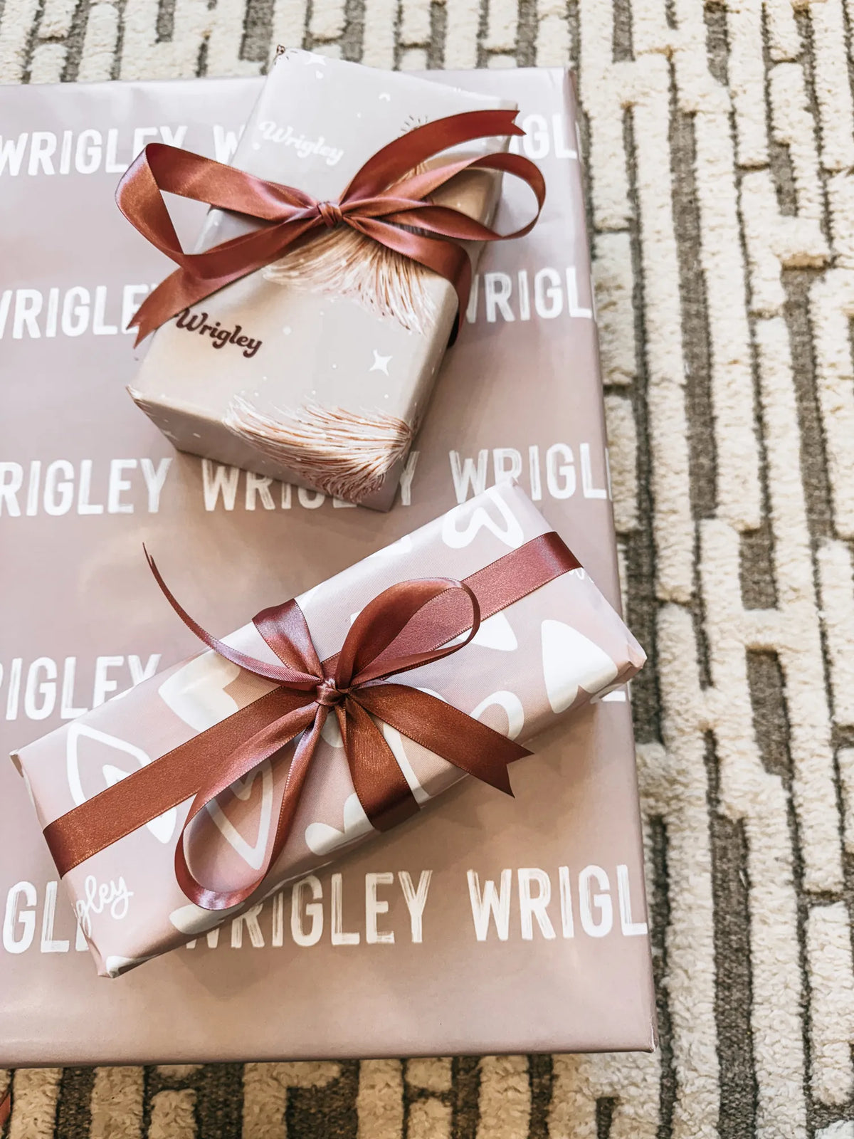 Gifts wrapped in paper printed with the name Wrigley, tied with ribbon